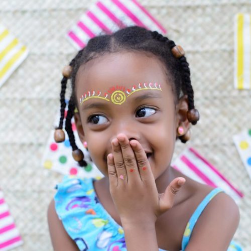 close-up-photo-of-smiling-girl-covering-mouth-1445465-1024x1024